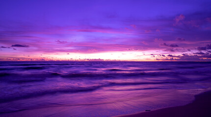 Cyberpunk color trend popular background.Nature beautiful Light Sunset or sunrise over sea Colorful dramatic majestic scenery Sky with Amazing clouds and waves in sunset sky purple light cloud