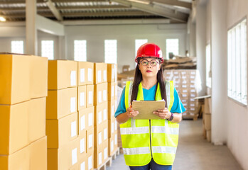 Warehouse worker inspecting checklist cargo shipment and checks production products for load into a...