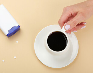 Coffee cup with saccharin pills.