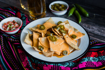 Mexican nachos chips with american cheese, beer and jalapeños in Mexico Latin America	