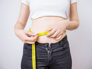 woman makes a measurement of the waist with a measuring tape, waist