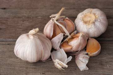 Garlic bulbs on wooden background.