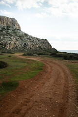 Ground red road to Cape Greco and sea on the background in Ayia Napa