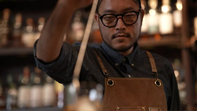 Night club concept of 4k Resolution. A bartender is mixing drinks for customers in a restaurant. A group of specialized clubs that sell alcoholic beverages.