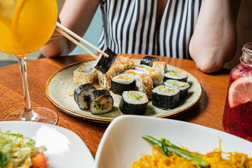 woman eating sushi in the cafe