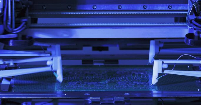 Close-up working moving four needles on automatic equipment manufactoring of microchips. Process of production of microcircuits and circuit boards, micro soldering of chips. High-tech technologies.