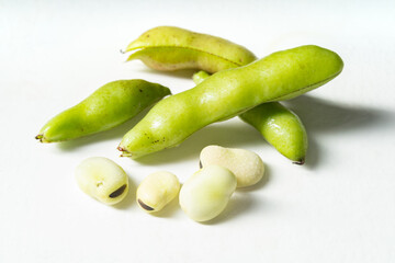 Fresh broad beans on a solid color background