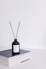Aromatic Diffuser on books stack. Home office decoration desk concept.