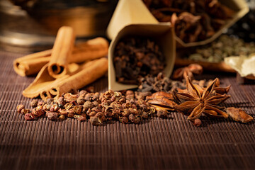 Chinese traditional seasoning five spice powder and raw materials on retro background
