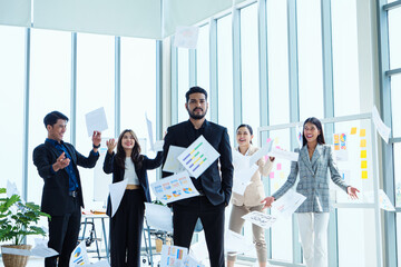 Group of happy smile successful business people in office corporate having fun throwing documents. Unity and Asian teamwork concept.Team Success, Paper sticky notes  