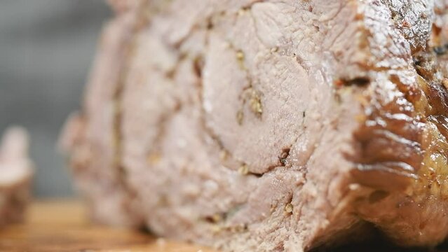 Piece of juicy roasted pork neck roll.
