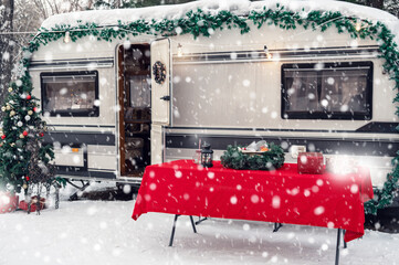 Modern campervan motorhome in winter camping decorated for Xmas or Happy New Year holiday