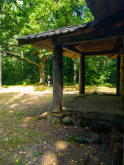 Old medieval wooden building church in the forest. 25 july 2022, Minsk, Belarus