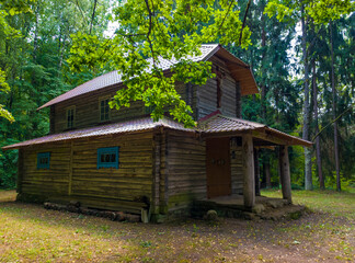 Old medieval wooden building church in the forest. 25 july 2022, Minsk, Belarus