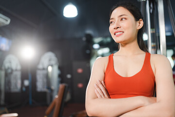 Obraz na płótnie Canvas young Asian woman person exercise in fitness gym for building a beautiful slim body, healthy training of athletic female in sport lifestyle, attractive girl doing weight active wellness in happy
