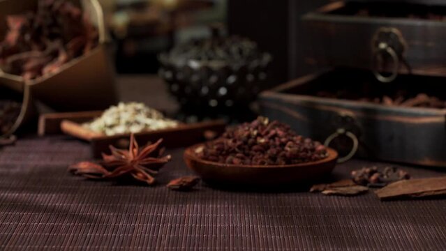 Chinese traditional seasoning five spice powder and raw materials on retro background