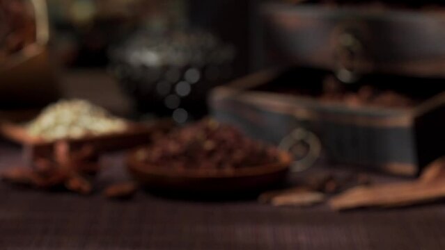 Chinese traditional seasoning five spice powder and raw materials on retro background