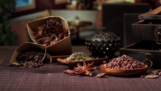 Chinese traditional seasoning five spice powder and raw materials on retro background