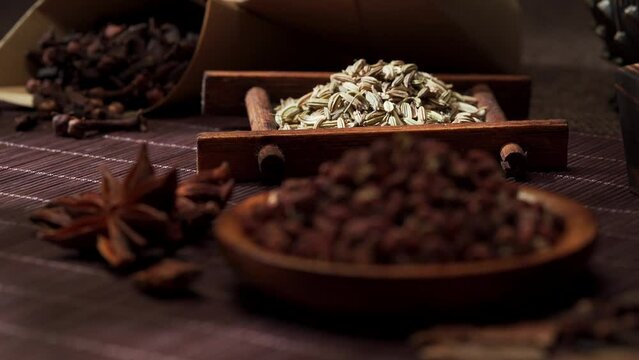 Chinese traditional seasoning five spice powder and raw materials on retro background