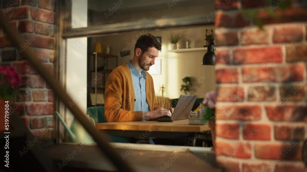 Poster handsome creative male entrepreneur working remotely on a laptop computer from home. freelance entre