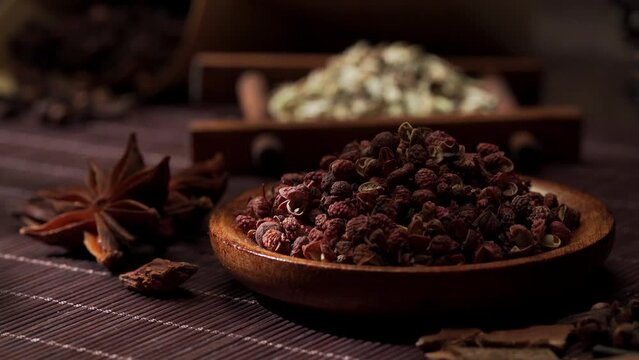 Chinese traditional seasoning five spice powder and raw materials on retro background