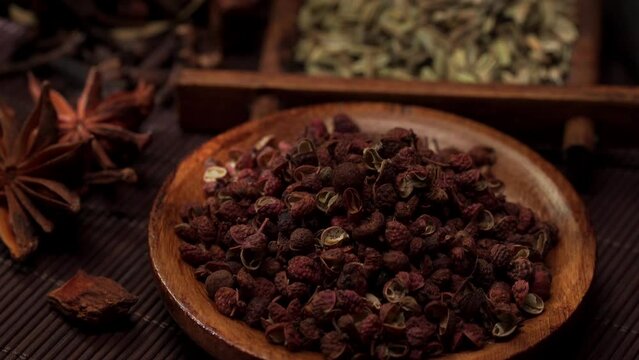 Chinese traditional seasoning five spice powder and raw materials on retro background