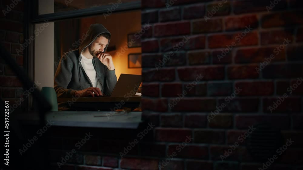 Poster information technology specialist working late on a latptop. software engineer wearing hoodie, worki