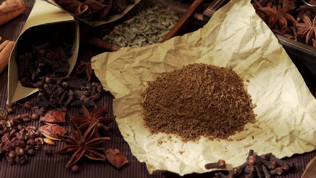 Chinese traditional seasoning five spice powder and raw materials on retro background