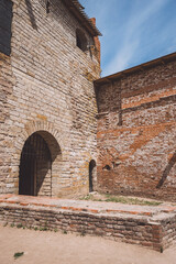 Fototapeta na wymiar Arched entrance to the ancient brick fortress. photo vertical