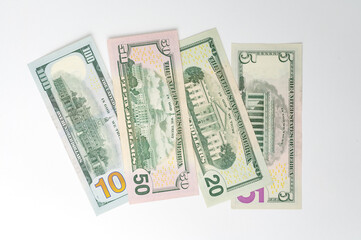 5, 20, 50, 100 dollars banknotes at different angles. Close up of dollars on white background.
