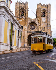 Yellow tram no. 28 at the Cathedral of Sé in Lisbon. Portugal - obrazy, fototapety, plakaty