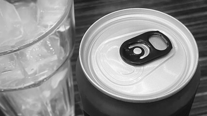 Closed up of Aluminum red soda can with a glass of ice cubes. Black and white tone
