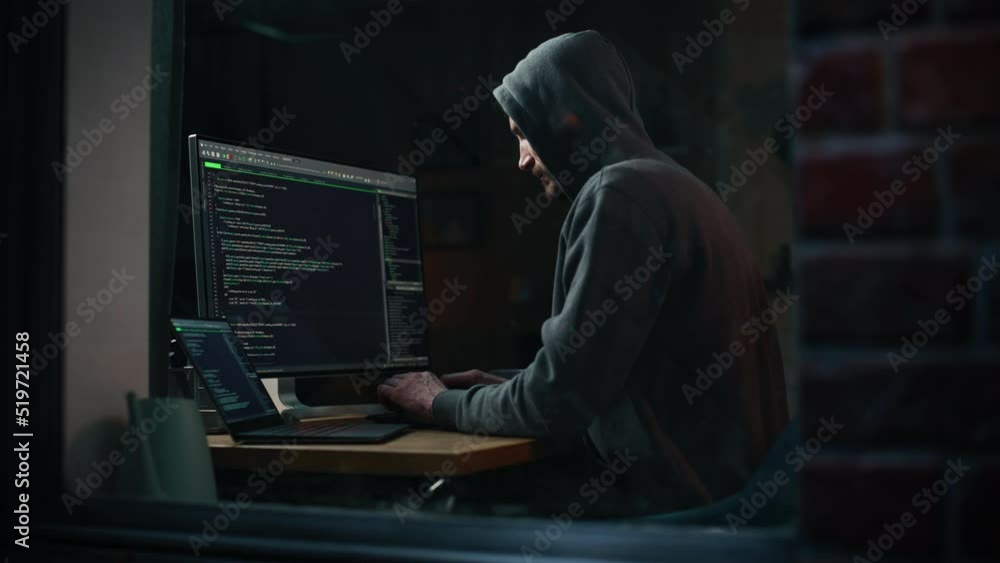 Leinwandbilder night apartment: evil greedy hacker wearing hoodie breaks into data servers, does ddos attack, phish