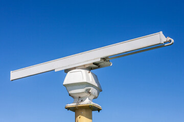 Radar on a ship with a blue sky