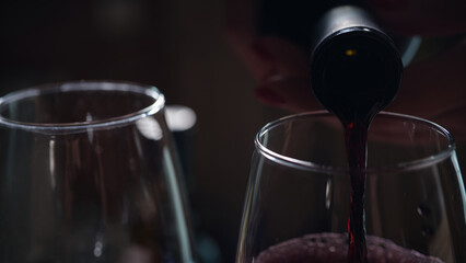 Pouring red wine into glass, tasting and degustation