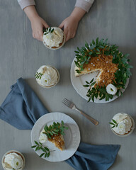 Delicious pastries decorated with flowers and greenery