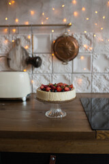 Pastries decorated with berries in the kitchen in a modern interior