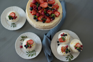 Pastries decorated with berries on a wooden background