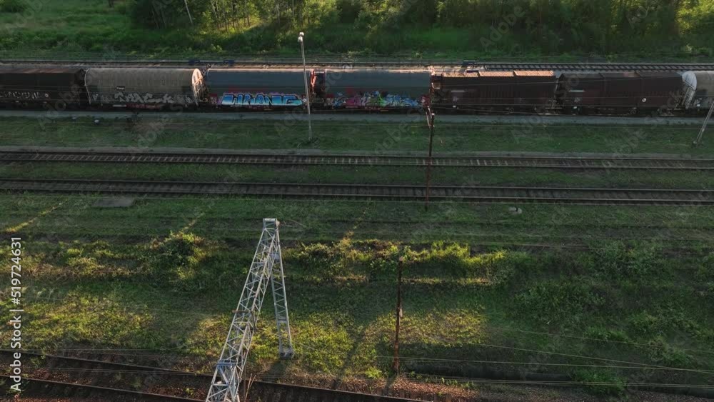 Poster the view from the drone on the railroad tracks against the background of the setting sun. concept of