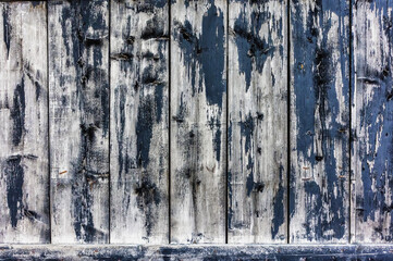 Old wooden painted wall with peeling paint