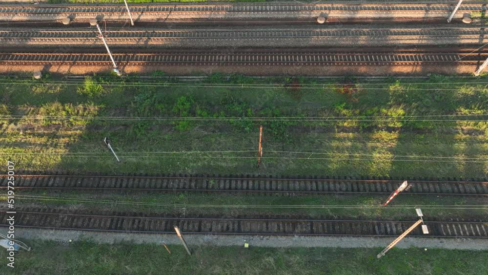 Poster the view from the drone on the railroad tracks against the background of the setting sun. concept of