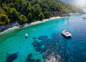 Aerial view of the beautiful Ftelia beach with emerald sea and Pine Trees at Skopelos island,...