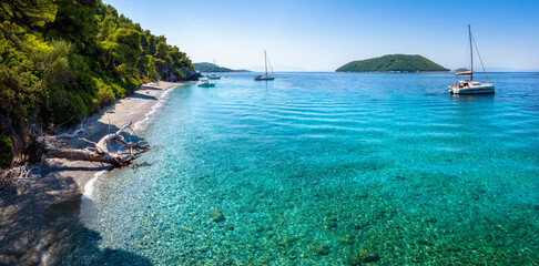 Panoramic view of the beautiful Ftelia beach with emerald sea and Pine Trees at Skopelos island,...