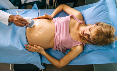 Pregnant woman during ultrasound scanning at the hospital, clinic.