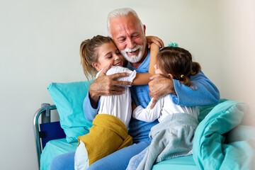 Happy grandfather is recovering from the coronavirus is visited by his grandchildren