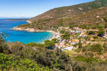View over colorful bay of little village and sandy beach of Cavoli, Elba Island, Province of...