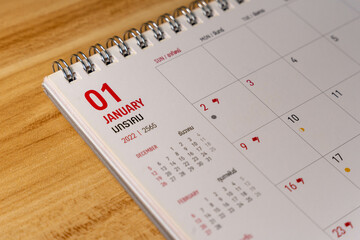 Jan month 2022 Calendar page on wooden background