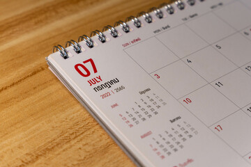 Jul month 2022 Calendar page on wooden background