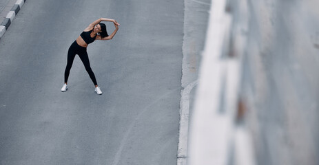 Fitness runner body close up, woman doing warm-up before jogging, stretching leg muscles, Female...