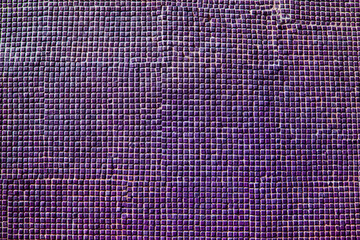 Close up of purple ceramic tiles on historical wall